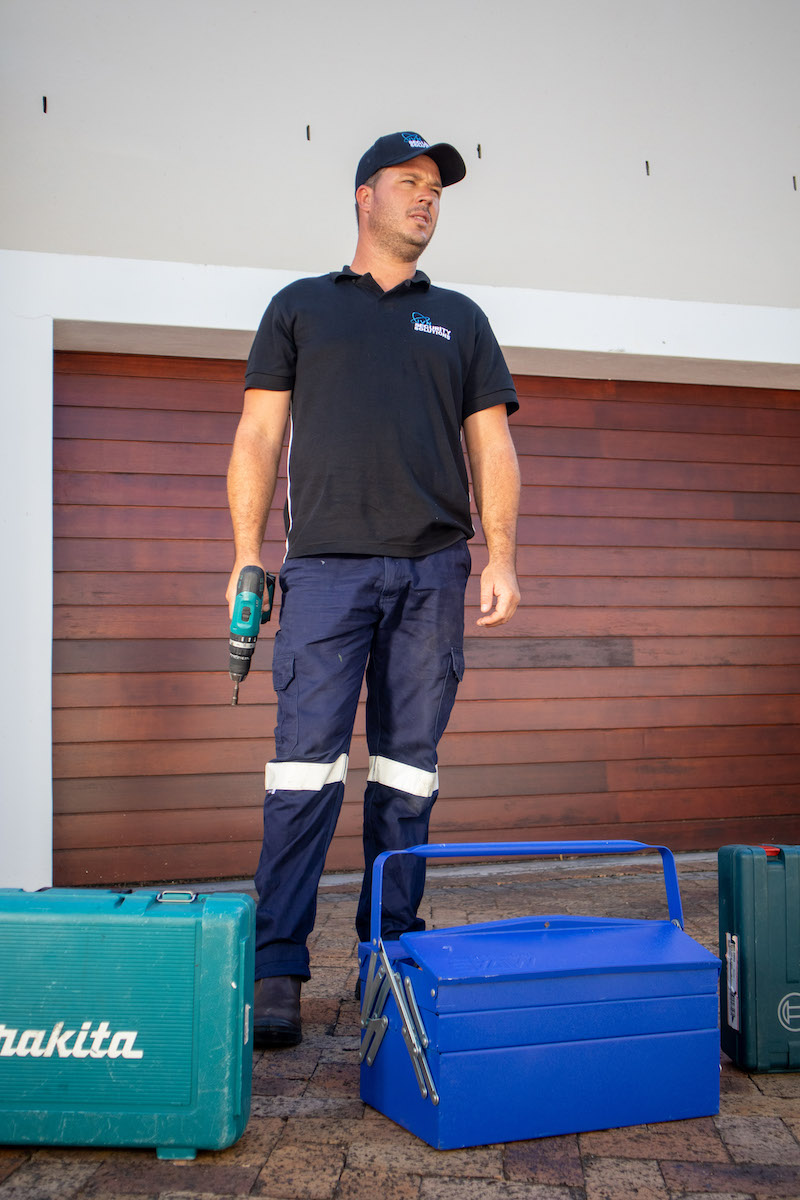 Man standing in front of a garage door