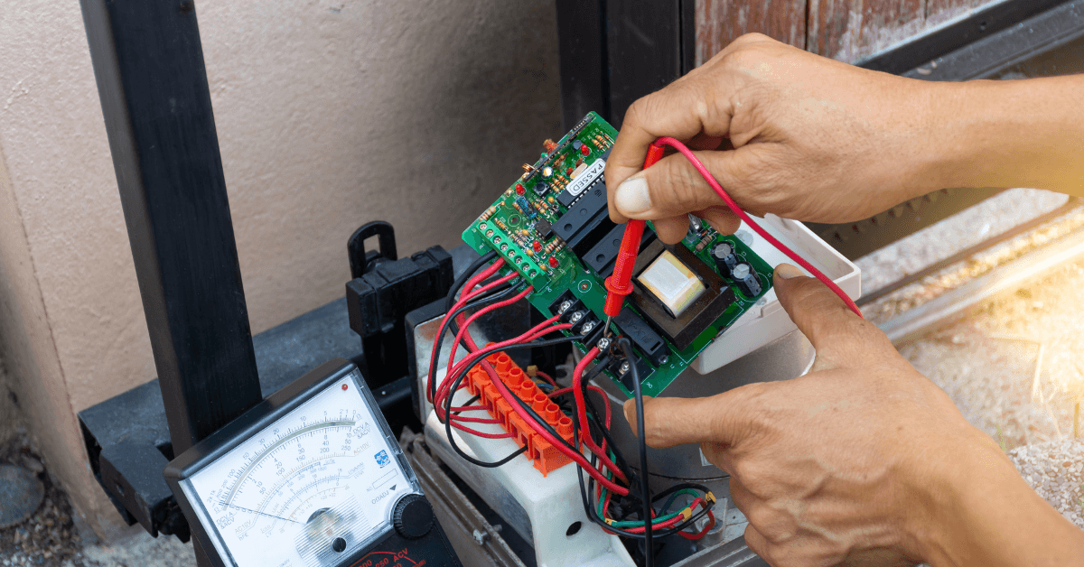 A person programming a sliding gates motor