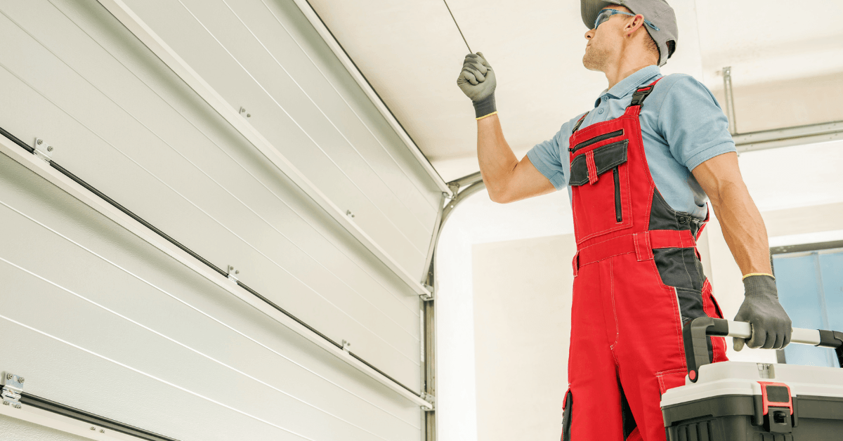Technician inspecting a garage door motor