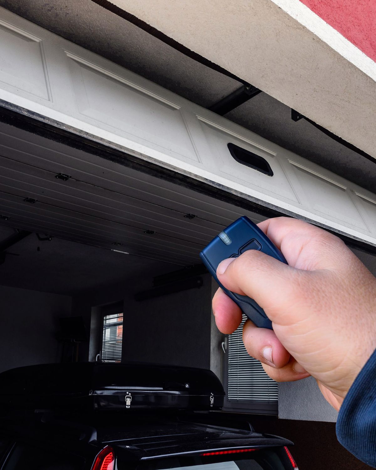 Person using a remote to open a garage