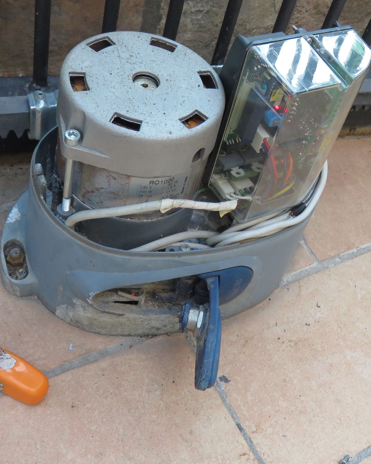 A gate motor being repaired