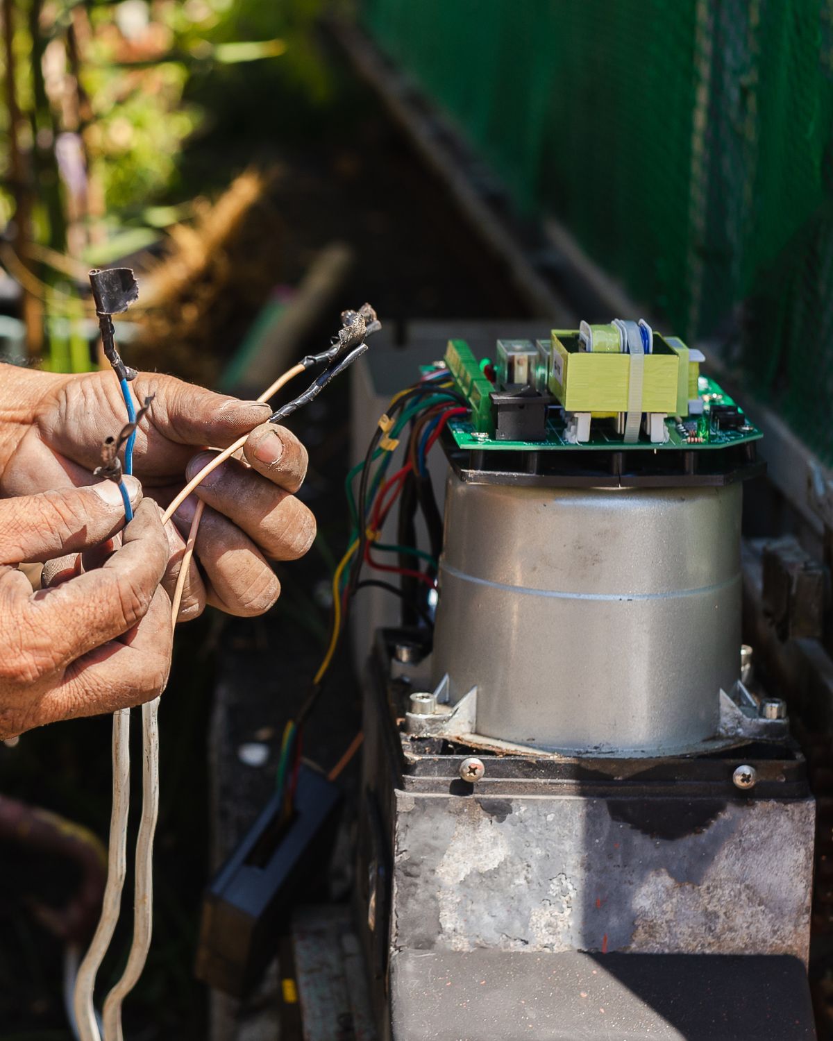 Man working on a gate motors wires